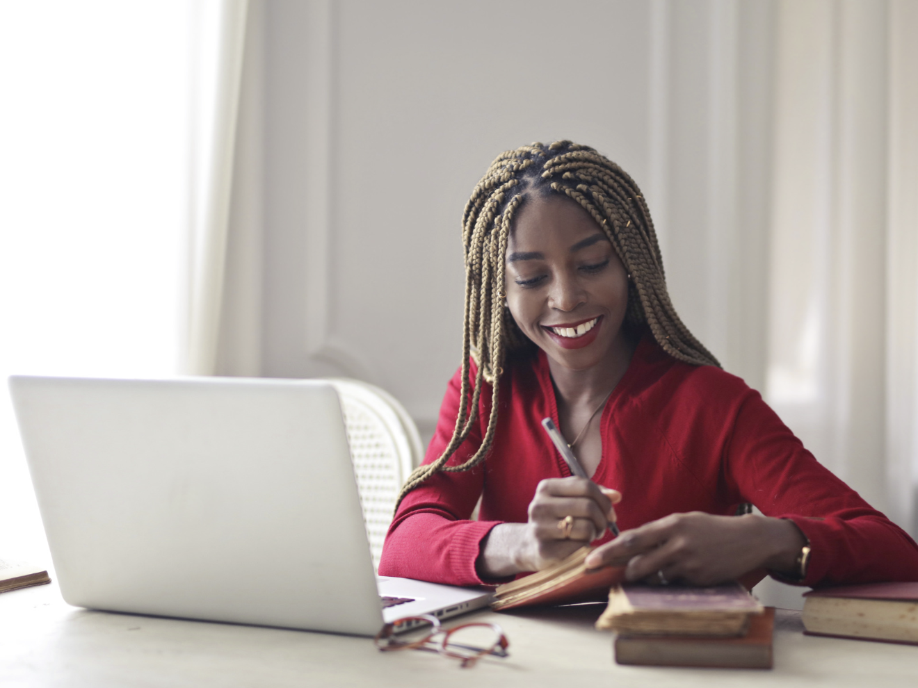 Stratum member consultant smiling while working at a laptop